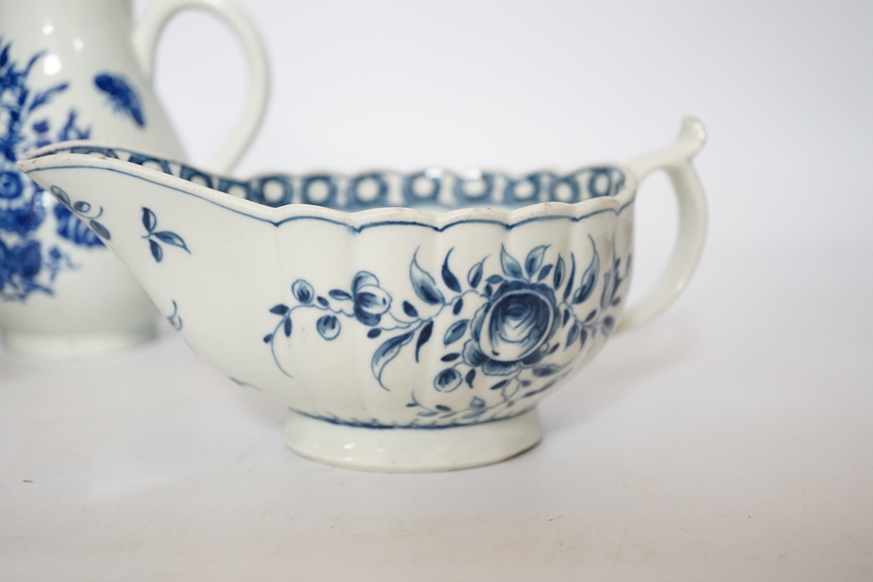 A Worcester rose pattern sauceboat c.1770 and two three flowers pattern milk jugs, largest 18cm wide